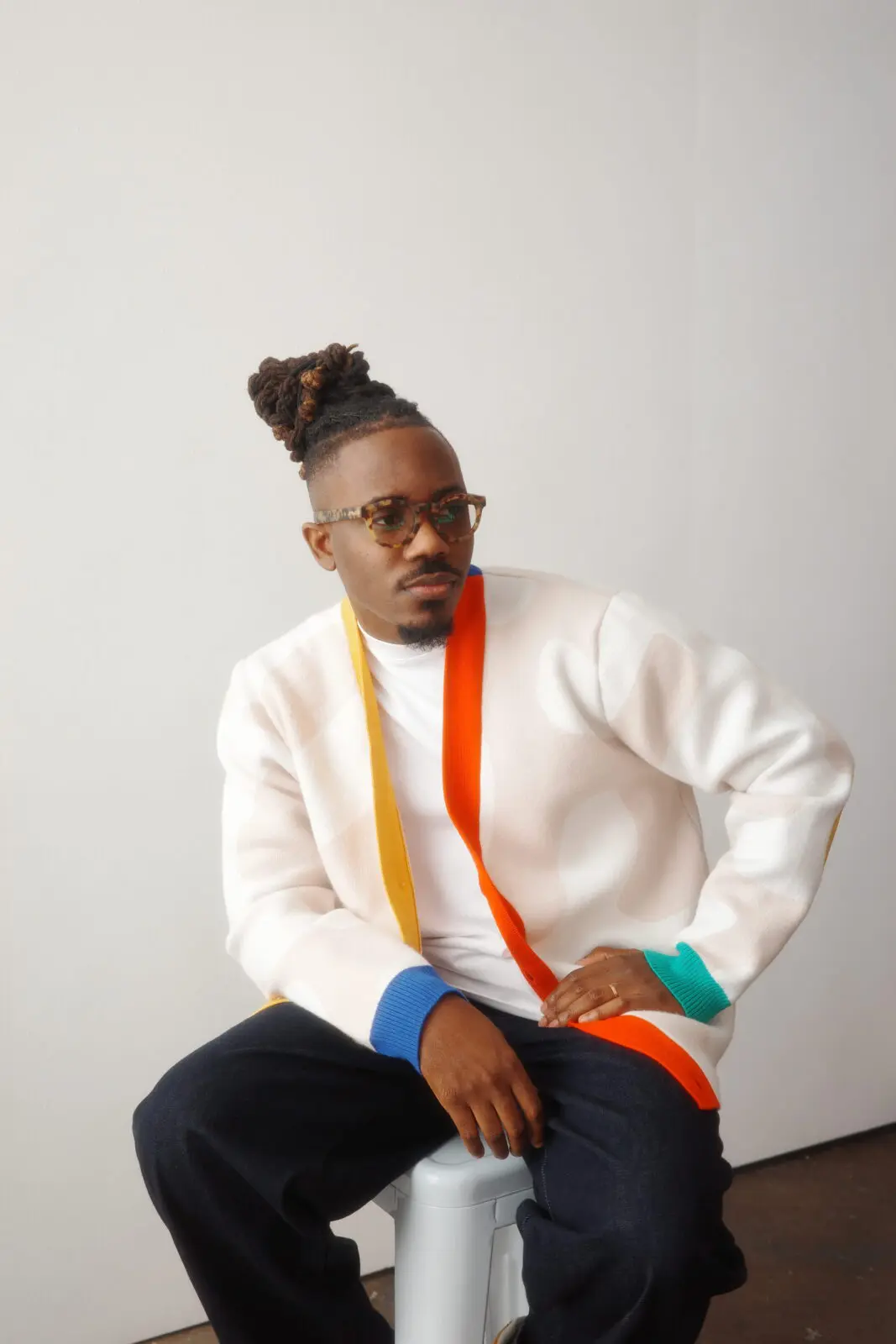 2018 Adobe Creative Resident Temi Coker sports a wool cardigan from his fashion collection.