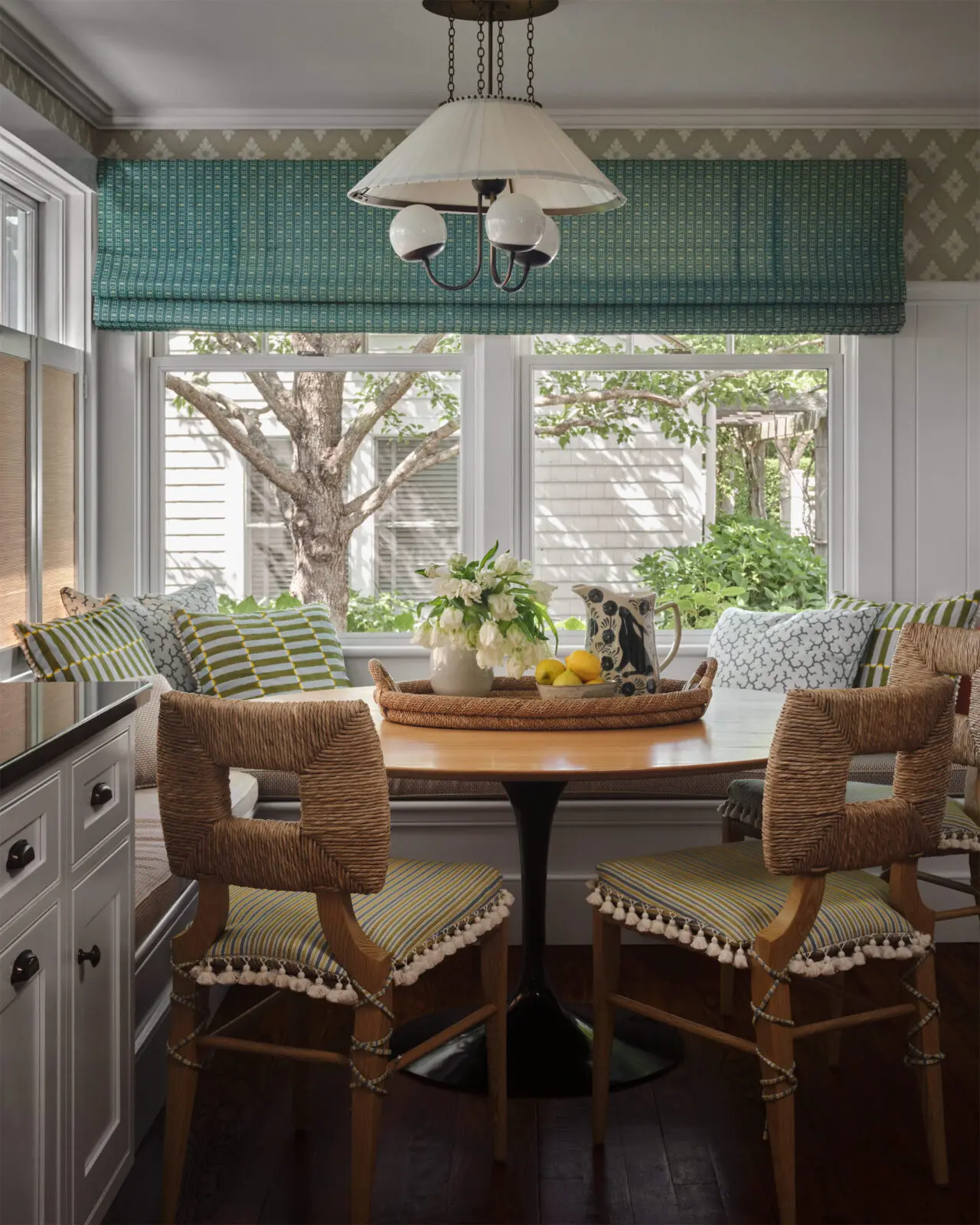 The breakfast-nook chairs from Hollywood at Home, L.A., are covered in Pierre Frey performance fabric. Farrow & Ball wallpaper. Pillows in a Schumacher block print and performance fabrics. RTO Lighting pendant light. (Photo by Douglas Friedman)