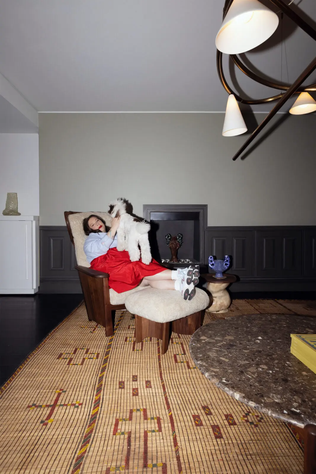Laura Young, pictured with Sketch Light Large – Sulfur Bronze by Anna Karlin; Twenty-Five Bergère Chair – Danish Oiled Walnut + Curly Sheepskin Mohawi and Twenty-Five Coffee Table by De La Espada; Side table and vessel by Rafi Ajl; and Bubble Handle Vase – Lilac by Natalia Triantafylli. Available exclusively at The Future Perfect. (Photo by David Sierra)