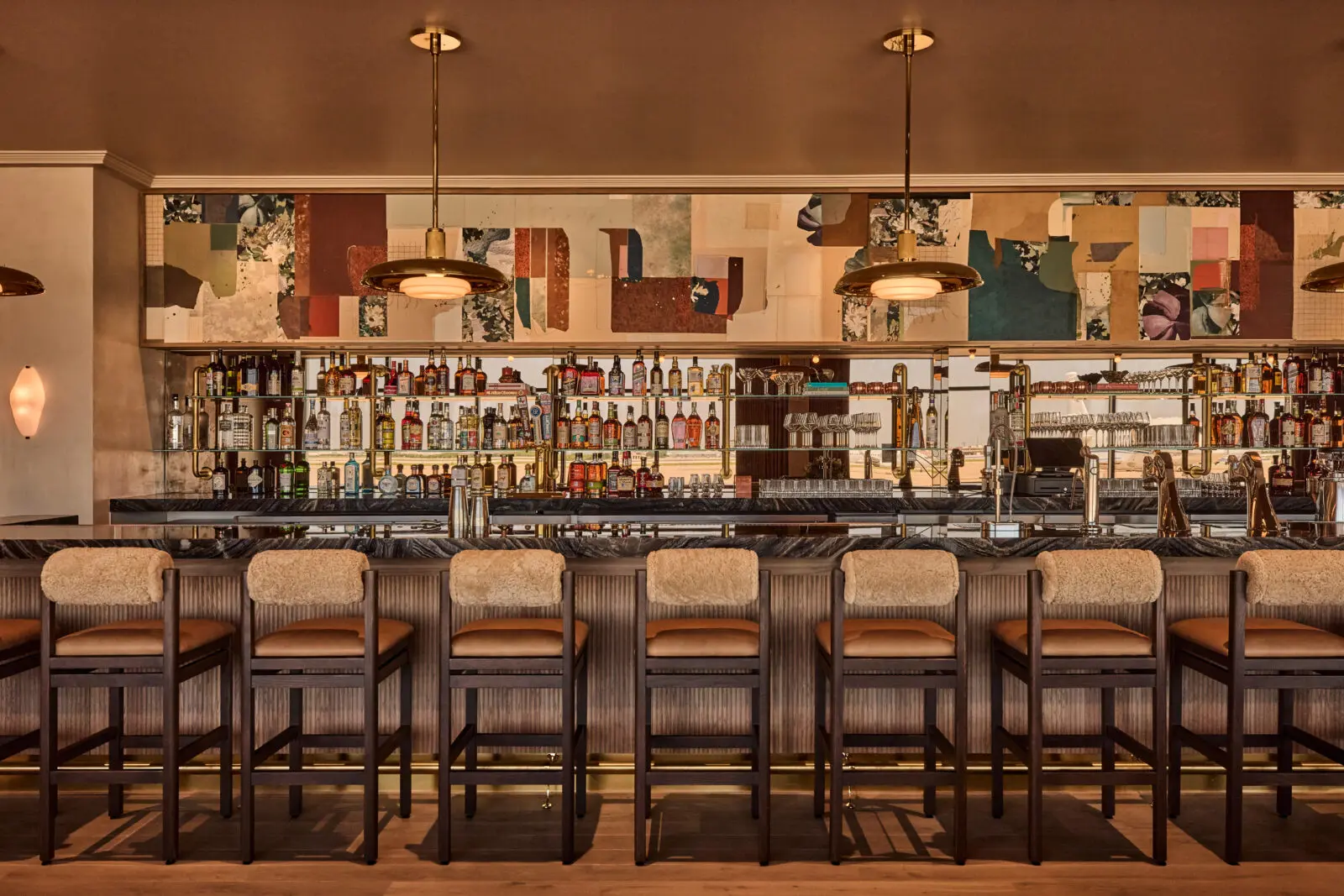 In The Salon, a 40-foot bar is a monumental ode to old-fashioned bars in the South, intended to be a true social gathering place and a spot to unwind before or after traveling. (Photo by Jenna Peffley)