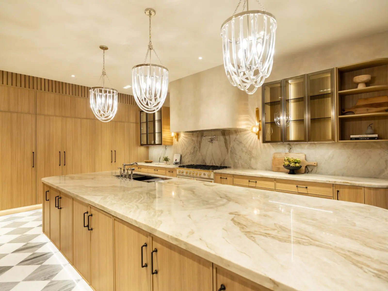 Cyrstal chandeliers provide dramatic lighting in the Belfiore penthouse kitchen (Photo by Harry Stonhill)
