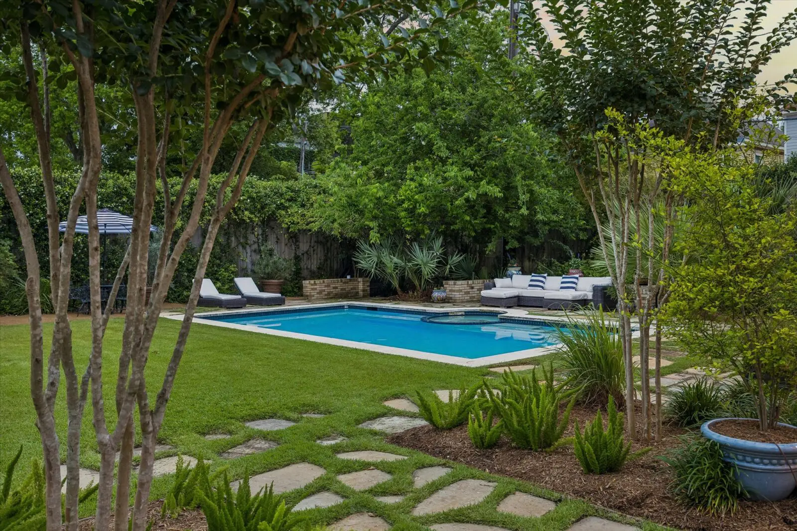 The pool and surrounding south lawn landscape at 15 Courtlandt Place were designed by Curtis & Windham Architects and Jane Curtis. (Photo by Tk Images)