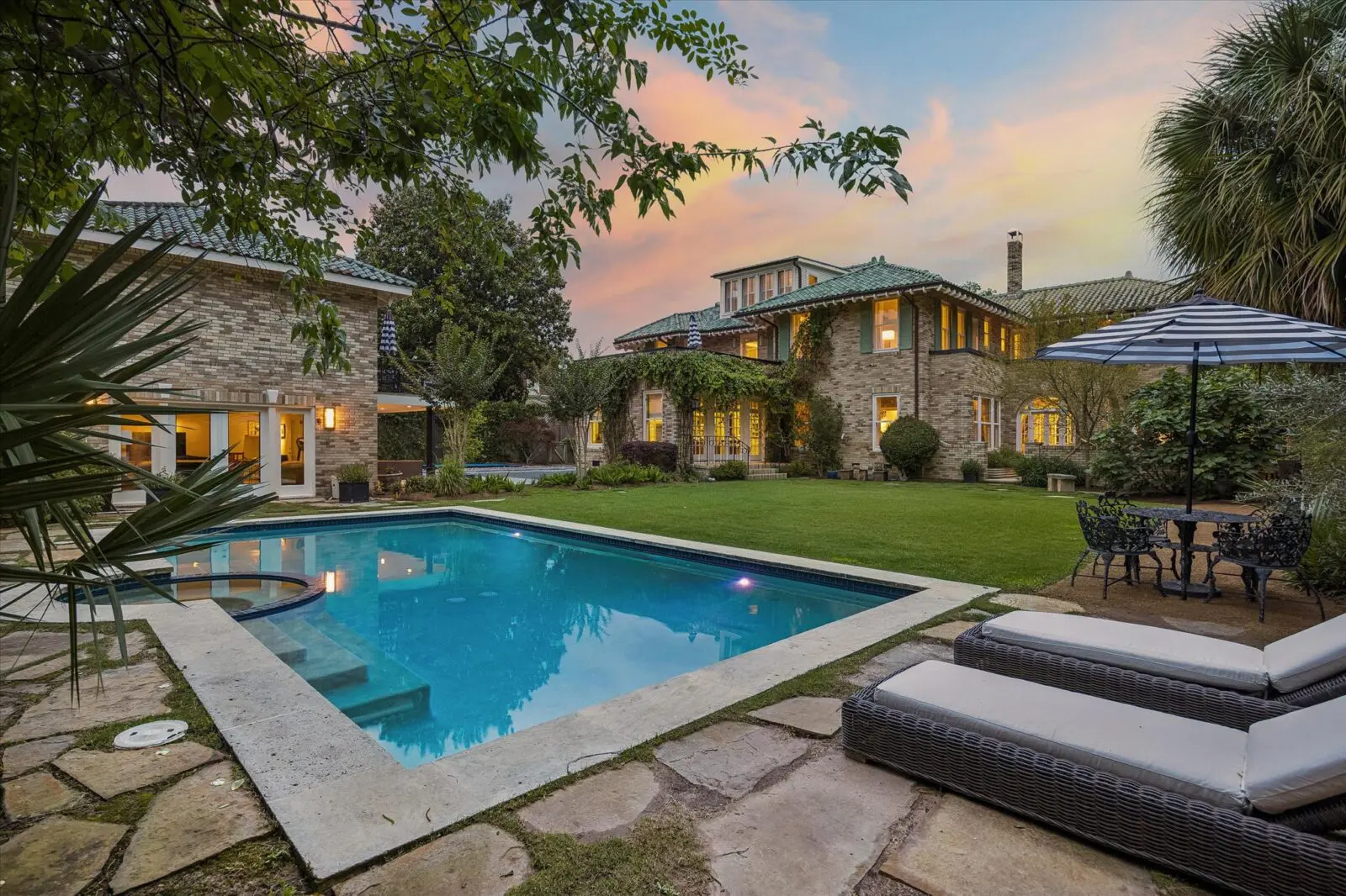 The pool and surrounding south lawn landscape at 15 Courtlandt Place were designed by Curtis & Windham Architects and Jane Curtis. (Photo by Tk Images)