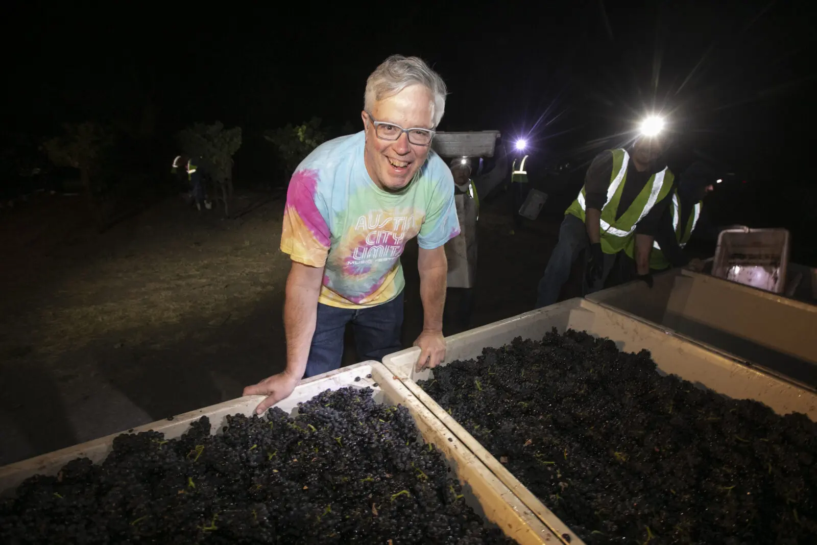 Adam Lee stands at bins of fruit during the 2023 Clarice harvest at Garys' Vineyard.