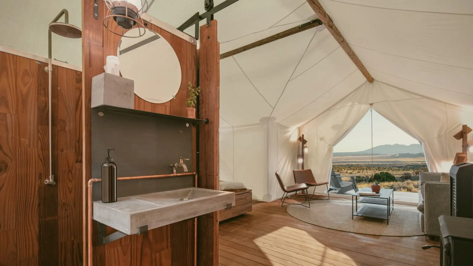 The tent interiors at ULUM Moab are outfitted with plush king beds, heated blankets, rain showers and private toilets for a true five-star glamping experience.