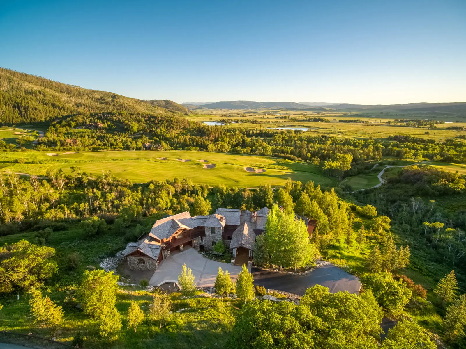 Designed by architect Joe Patrick Robbins, Covered Bridge sits on seven private acres overlooking the seventh fairway with sweeping south-facing views across the Yampa Valley and surrounding mountain peaks. 