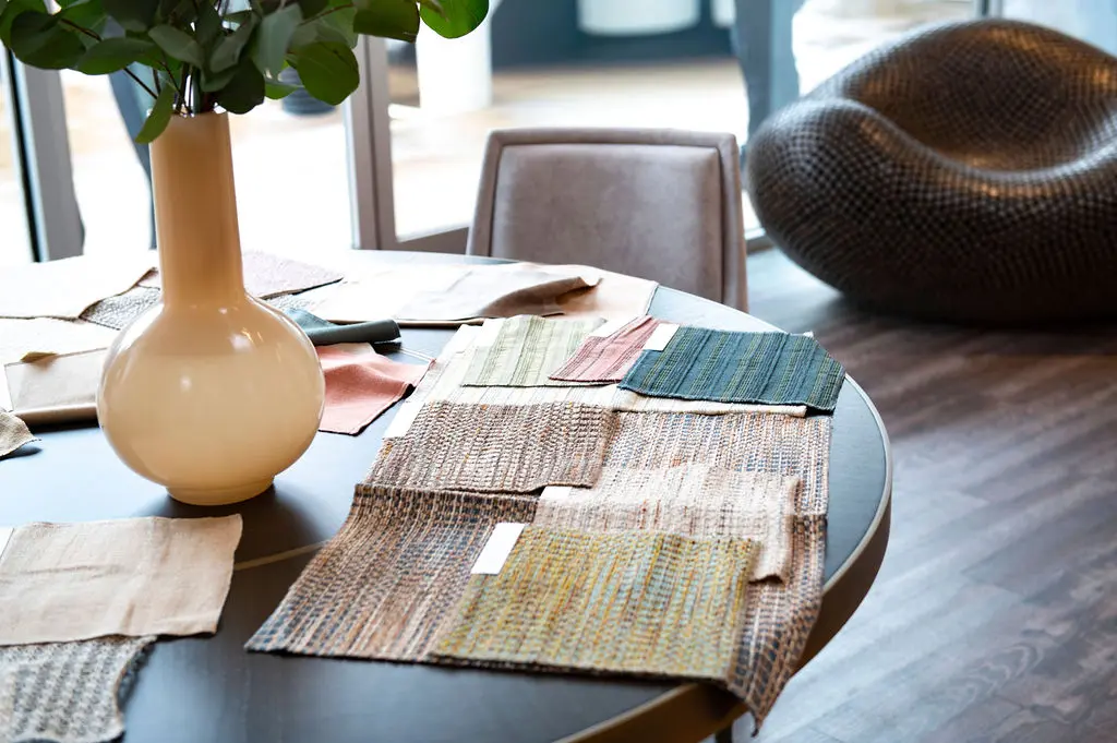 Samples were sprinkled on the tables, and guests had the opportunity to not only see but also feel the luxurious textiles. (Photo by Tamytha Cameron)