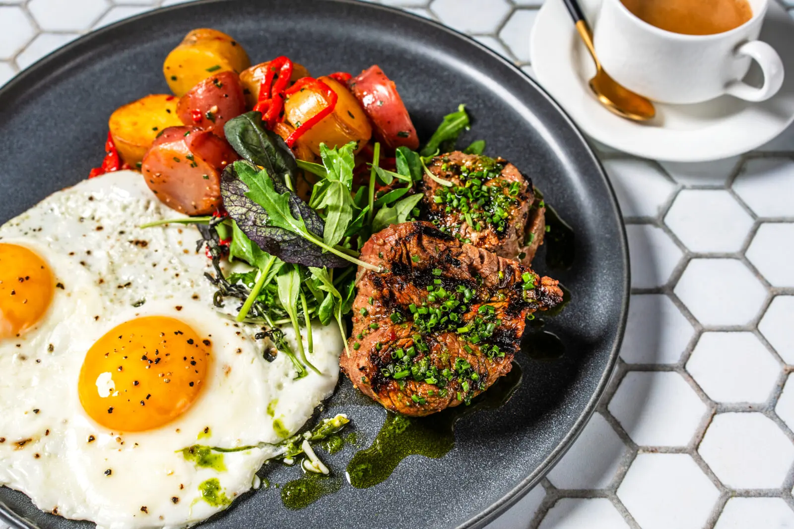 Tommy Bahama's Filet Mignon and Eggs pairs a tender steak with over-easy eggs, herb chimichurri and breakfast potatoes. (Photo courtesy Tommy Bahama)