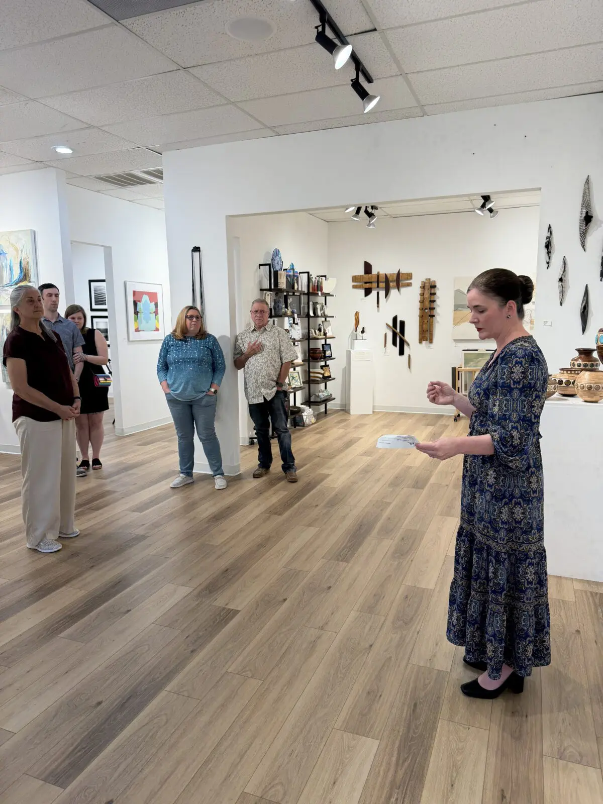 Gallery owner Julie Verville shared remarks and awarded ribbons to three artists at the opening for "Thresholds." (Photo by Laura Landsbaum)