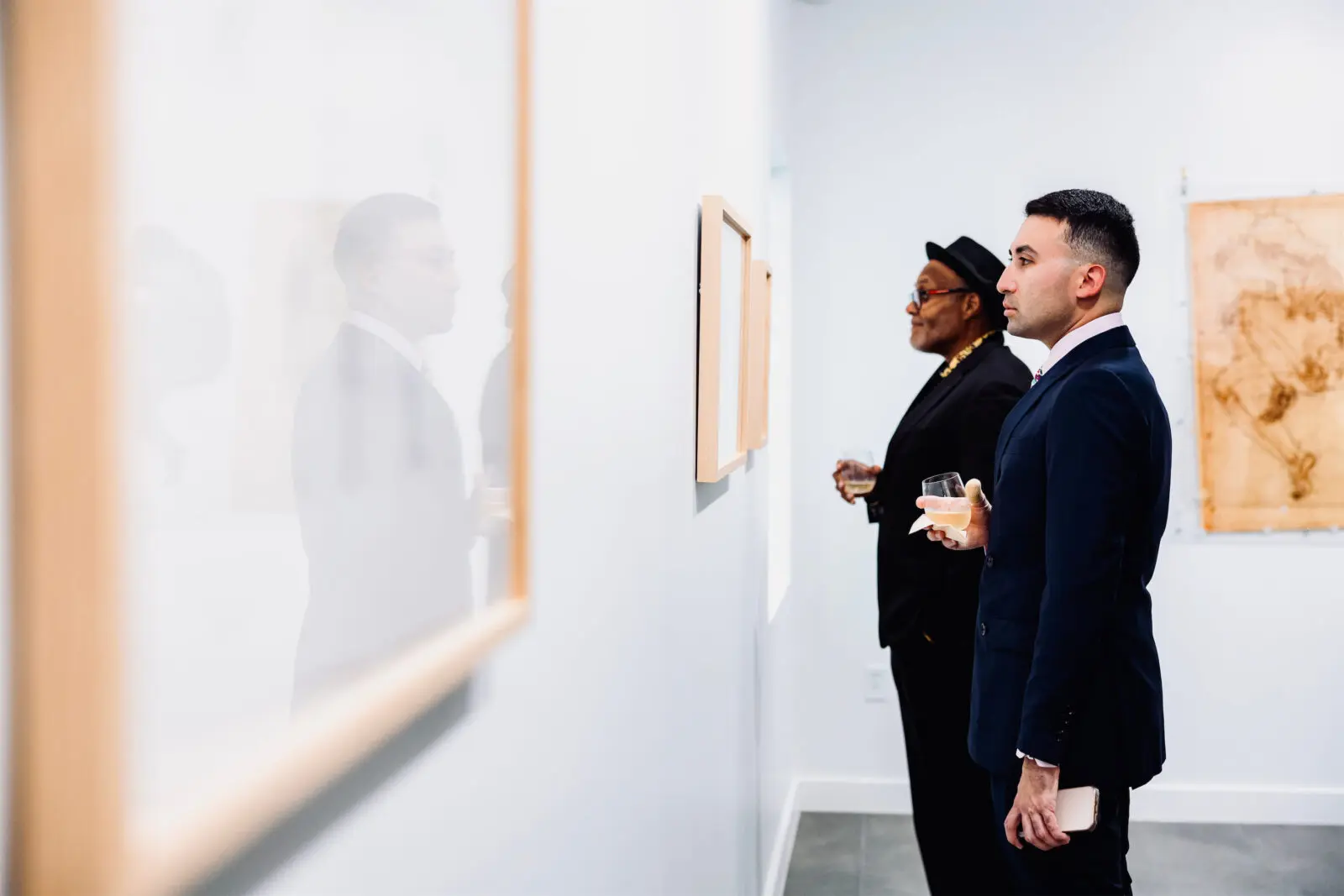 Stephen M. Miranda (foreground) and Daryl Basham (background) take in Mel Chin's "Living Score" at the Houston Arts Alliance Gilded & Golden Kickoff (Photo by Hung L. Truong)