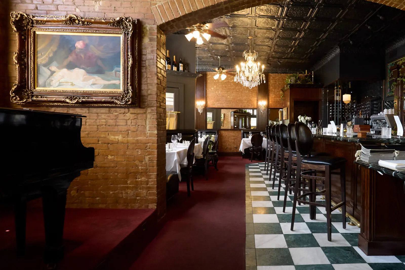 The new St. Martin's space features black-and-white checkerboard floors, chandeliers, and a piano — retaining the classic charm of the original while offering a refreshed feel. (Courtesy)