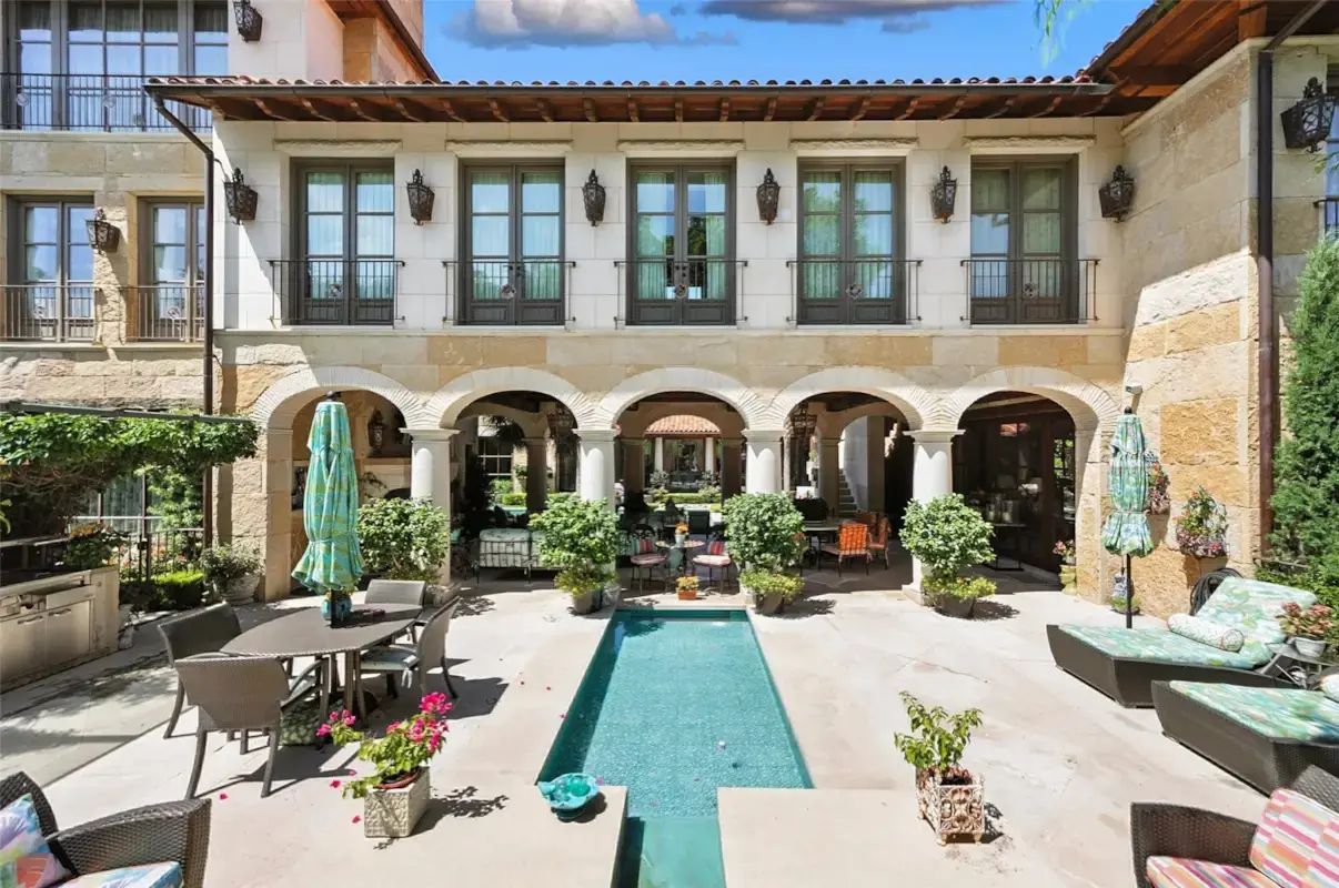 A formal courtyard pool anchors one of several outdoor living spaces found throughout 6236 Indian Creek Drive. (Courtesy)