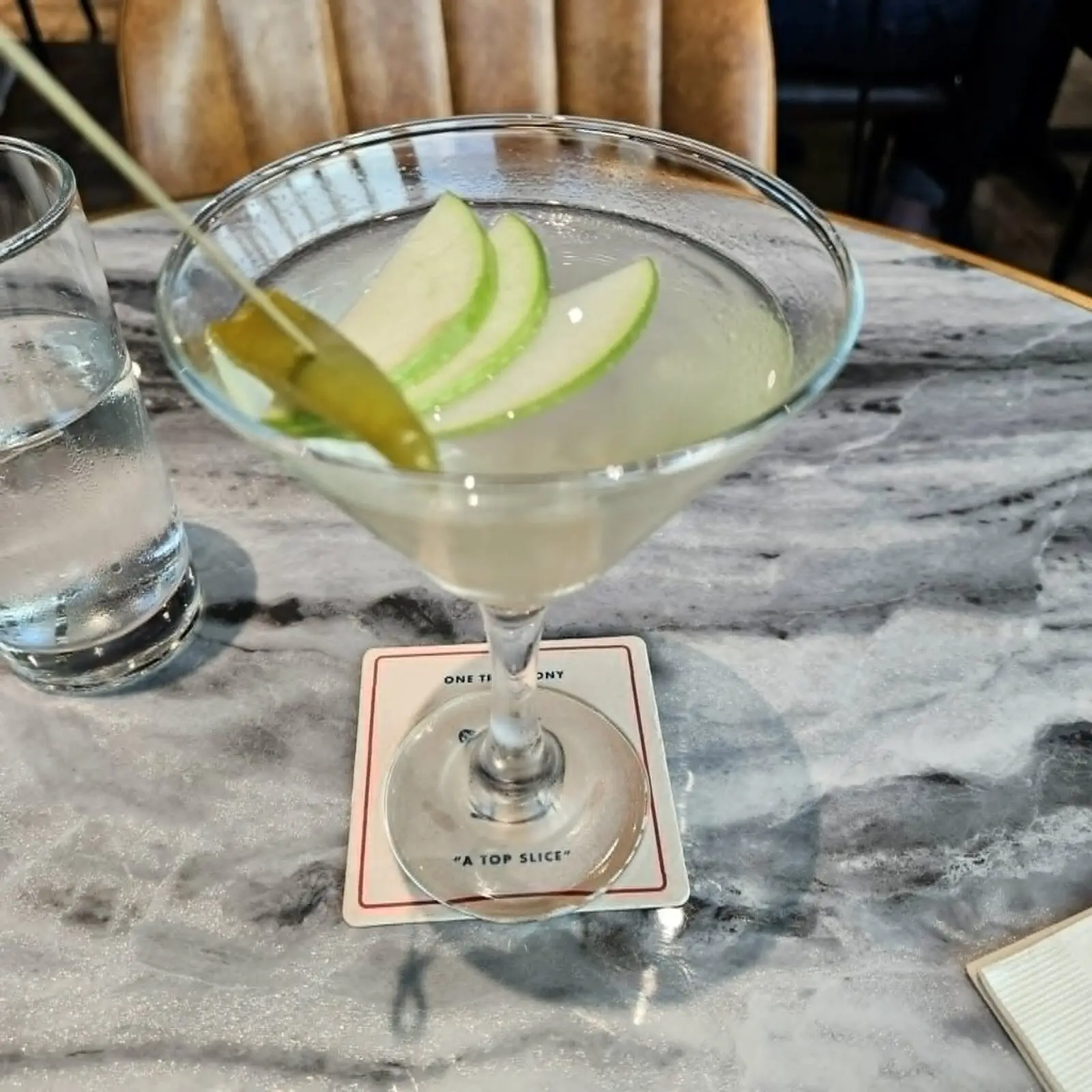 The Pepperoncini Tini, a rum-based martini made with premium Italian white vermouth and topped with a pepperoncino and slices of Granny Smith apple, is a delightful cocktail served at One Trick Pony Pizza Tavern. (Courtesy)