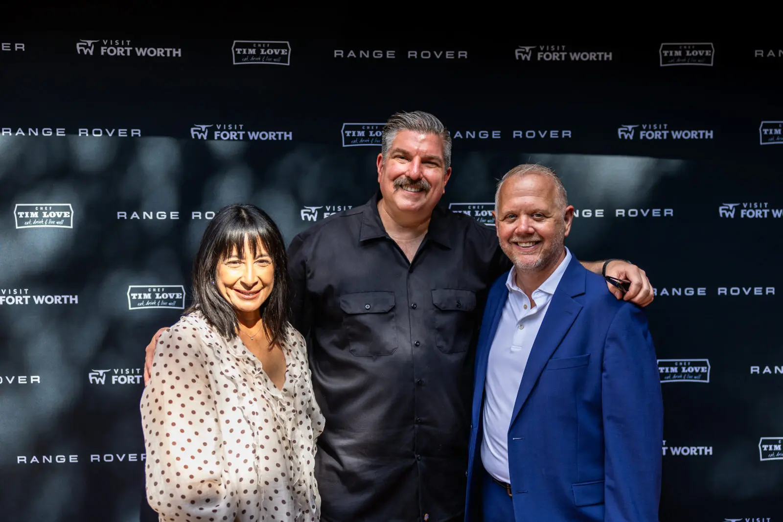 Daniel Syvrud (right) takes a photo with guests.  (Photo by Land Rover Fort Worth)