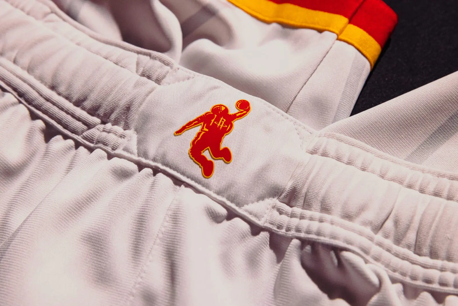 The Houston Rockets' new uniforms have the Dunkstronaut on the waistband.