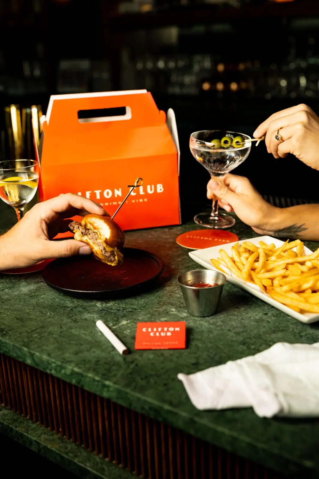 Show up post-dinner around 11 pm, wear some current-collection Celine, cozy up in a banquette with your paramour, and order the Kids Meal to share at Clifton Club. (Courtesy)