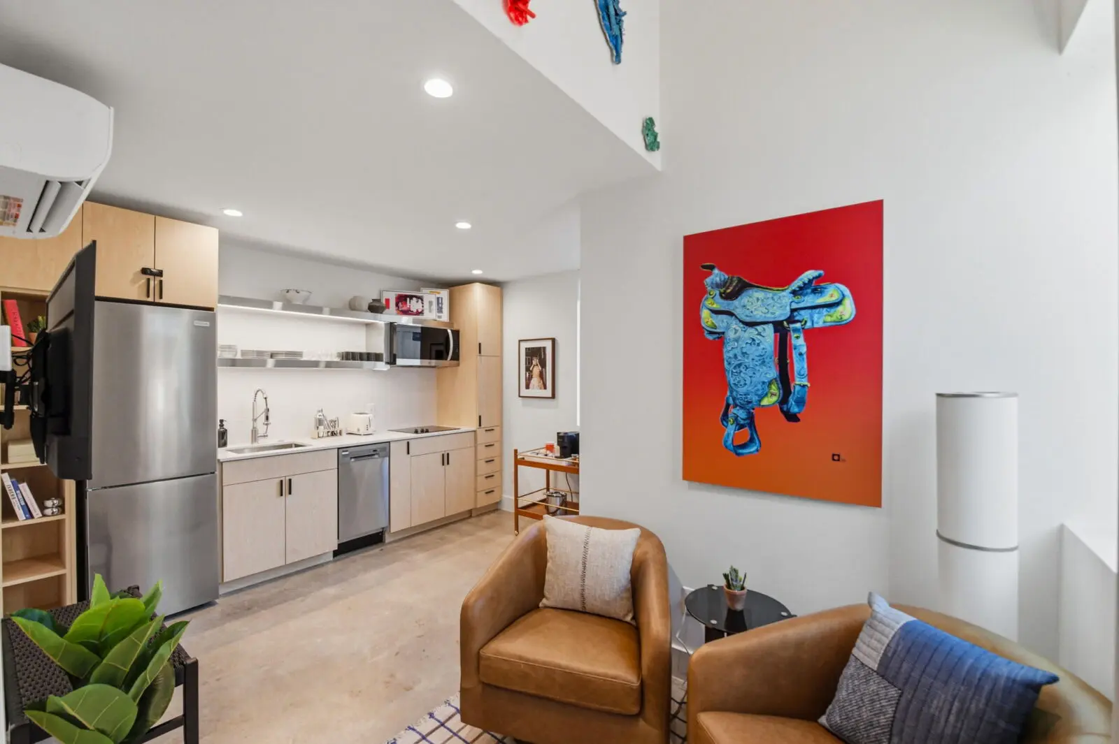 Inside a Hotel SOMA casita, soaring ceilings, full kitchens, cozy seating areas, and artwork sourced through William Campbell Contemporary create a stay that feels more like a stylish tiny home than a traditional hotel room. (Courtesy)