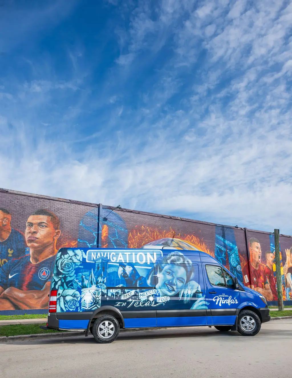 An artsy Ninfa's van appears beside artist José "Meenr" Arredondo's "Welcome Mural," 2026, at the Original Ninfa's on Navigation. (Photo by Shane Dante. Courtesy Rachel Austin PR)