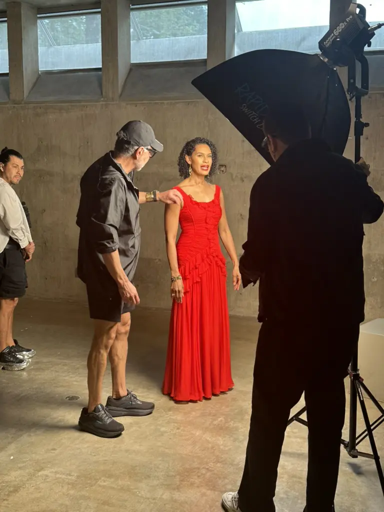 Ceron gives Erica Littlejohn Burnette, wearing Carolina Herrera, a coif touch-up at the Best Dressed photo shoot with Alejandro Salinas.