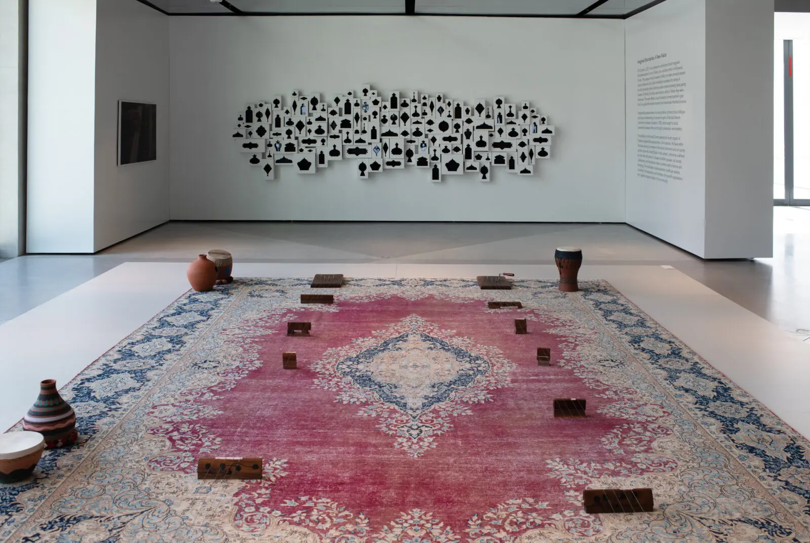Raheleh Filsoofi, "ShahTár," 2022. In the background, the artist's "Imagined Boundaries," 2025, at Ismaili Center Houston (Photo by Ali Ahad Dhukka)