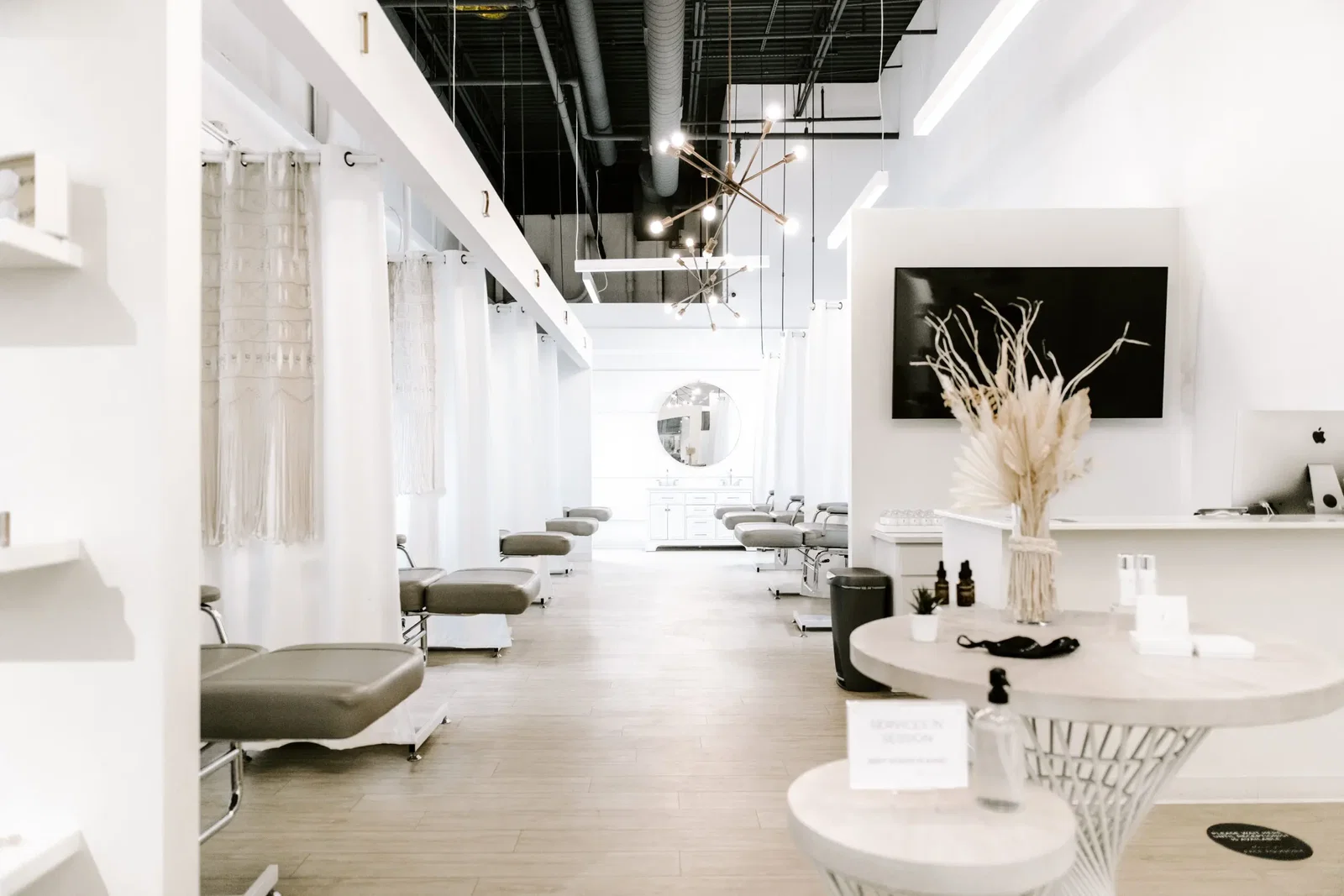 Every location features an open concept layout, where clients’ treatment areas are separated by a simple white curtain hung floor to ceiling for privacy, eliminating the private rooms found in other spas. (Photo by Love-Big-Live-Small-Photography).