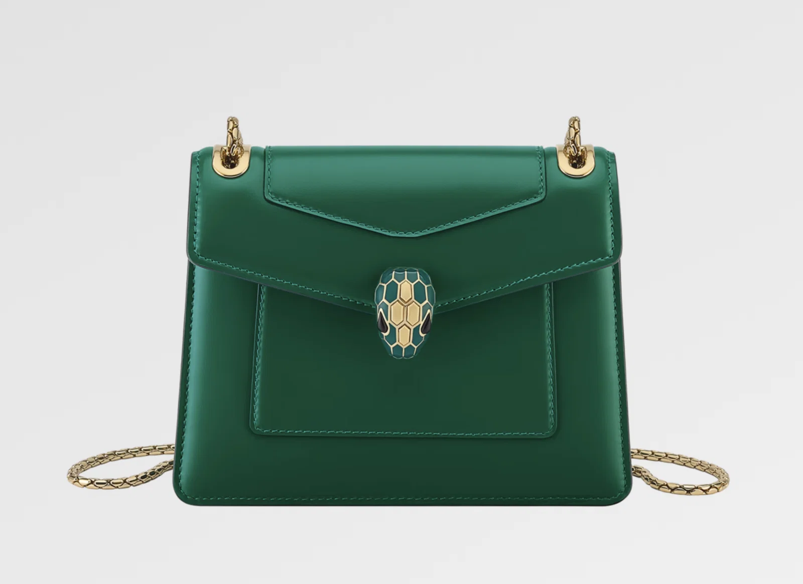 Serpenti Forever Day-to-Night shoulder bag in Smeraldo Prezioso leather with violet amethyst nappa leather lining, and snakehead closure in enamel and brass with onyx eyes, $3,500