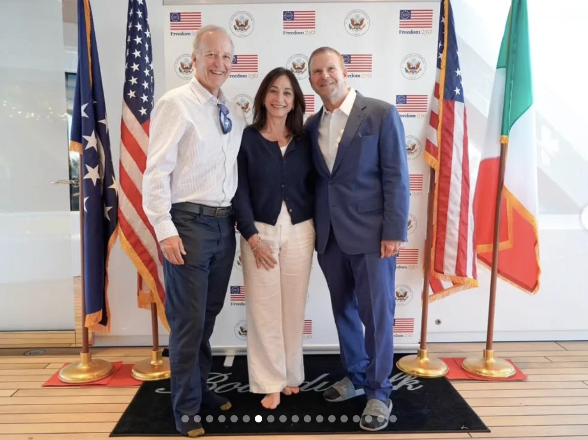Ambassador Tilman Fertitta poses for photo ops aboard his super-yacht  Boardwalk. Note the bare feet and Fertitta's slippers — yachting requisite, no shoes. (Instagram photo)