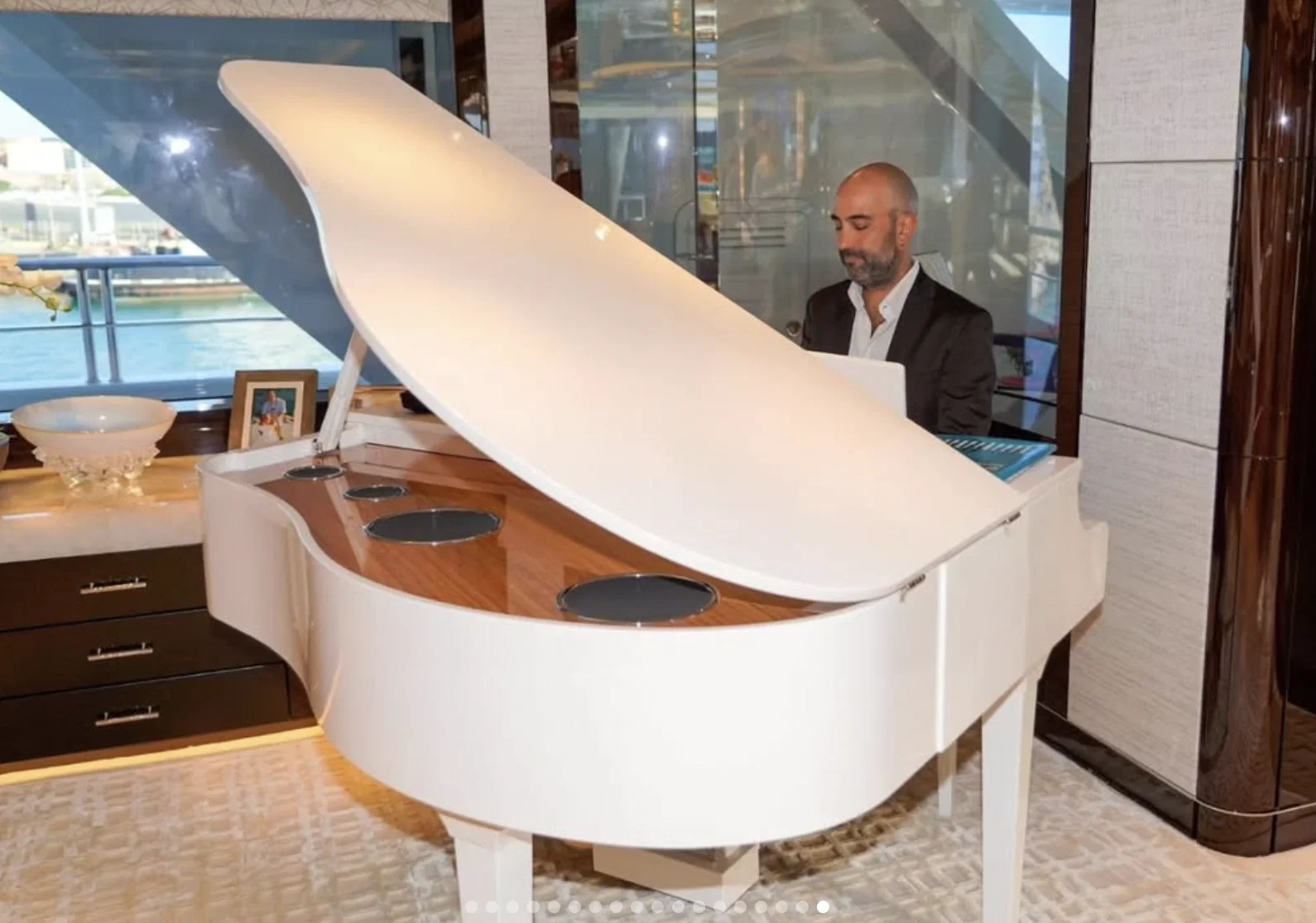 The baby grand piano provides a musical welcome to guests aboard Ambassador Tilman Fertitta's Boardwalk. (Instagram photo)