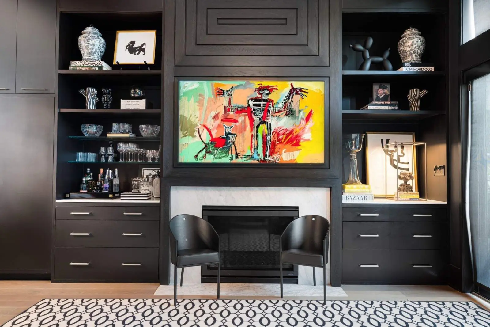 Custom millwork surrounds the fireplace with integrated storage and display, creating a tailored focal point that balances design and practicality.
 (Photo by Aria Media)