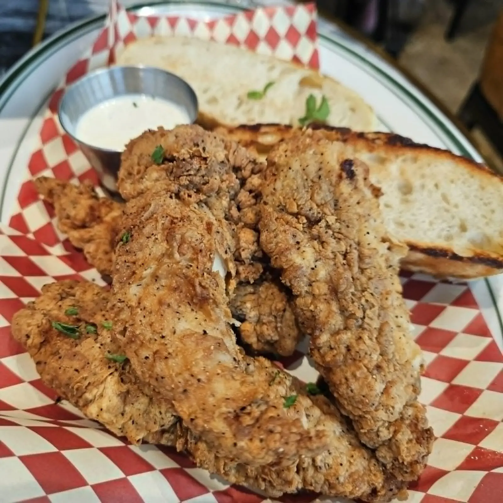 The chicken strips at One Trick Pony Pizza Tavern, which we topped with hot honey, were impossibly tender, likely due to a day-long brine. (Courtesy)