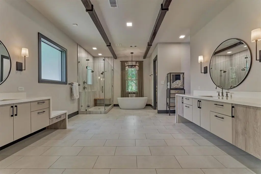 The primary bath at 64 Autumn Crest is open and bright.