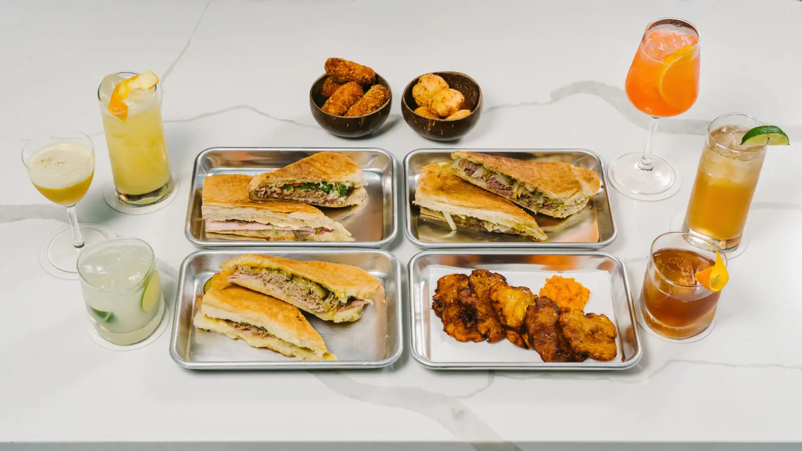 An array of Yuma's signature warm, pressed sandwiches, each of which is built on homemade Cuban-style bread. (Photo by Rebekah Flores)