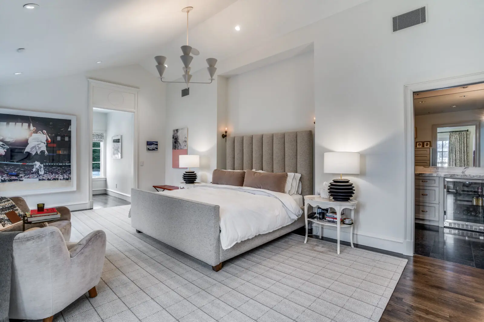 Vaulted ceilings flood the primary bedroom with natural light, and an attached balcony overlooks the creek. (Photo by Allie Beth Allman & Associates)
