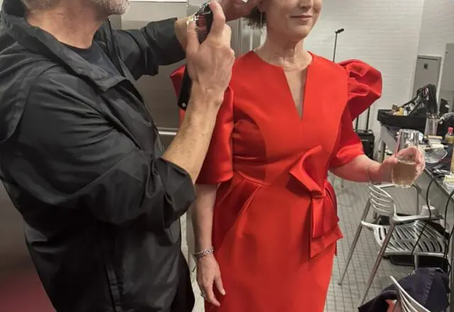 Hair stylist Ceron puts finishing touches on Leigh Smith's coif as she prepares for the Best Dressed photo shoot.