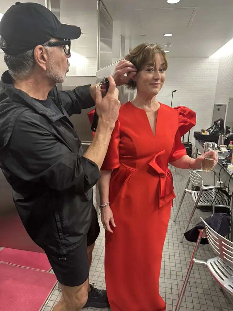 Hair stylist Ceron puts finishing touches on Leigh Smith's coif as she prepares for the Best Dressed photo shoot.