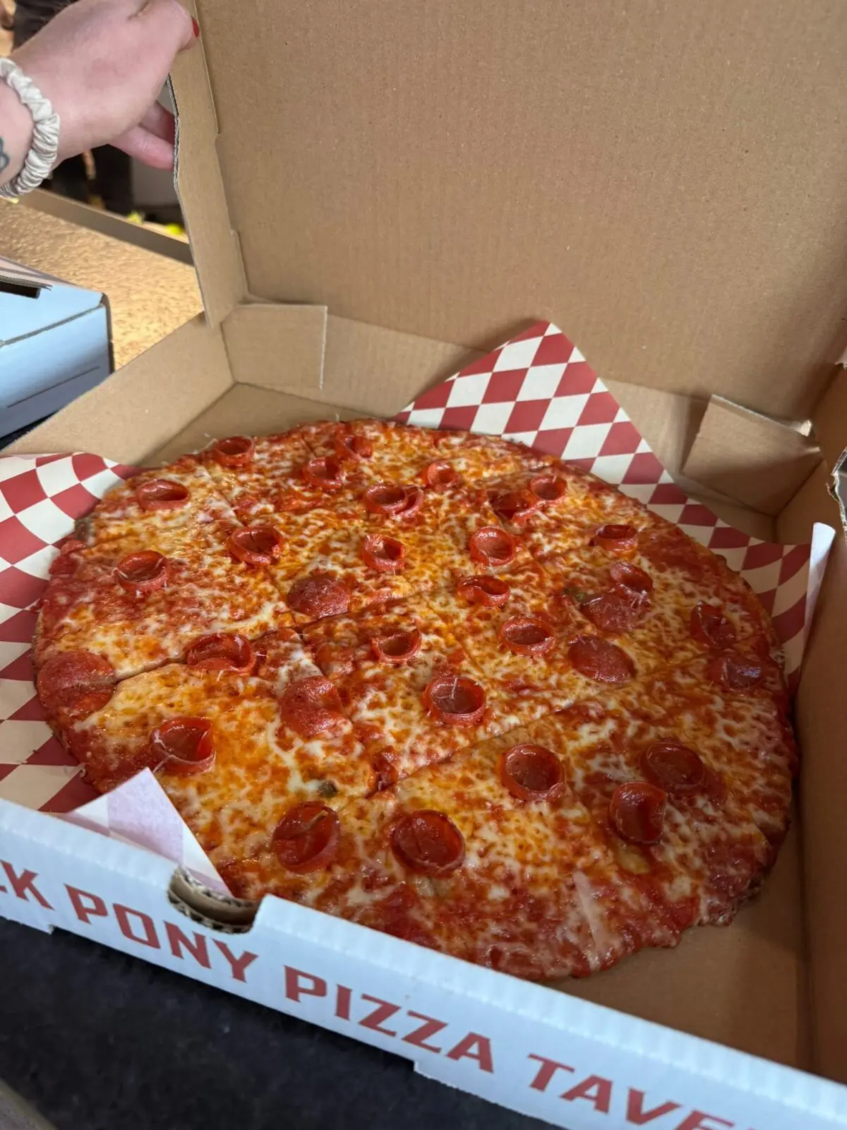 Travis Heim credits South Main’s momentum, his team, and growing interest in Chicago tavern-style pizza for One Trick Pony’s immediate popularity. (Photo by One Trick Pony)