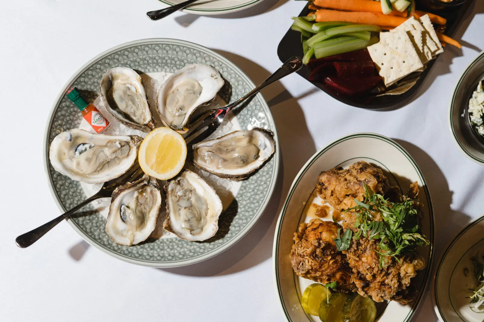 Fresh oysters and crispy fried chicken are among the menu offerings at The Vandy, Caravan Court Hotel's signature restaurant. (Courtesy)