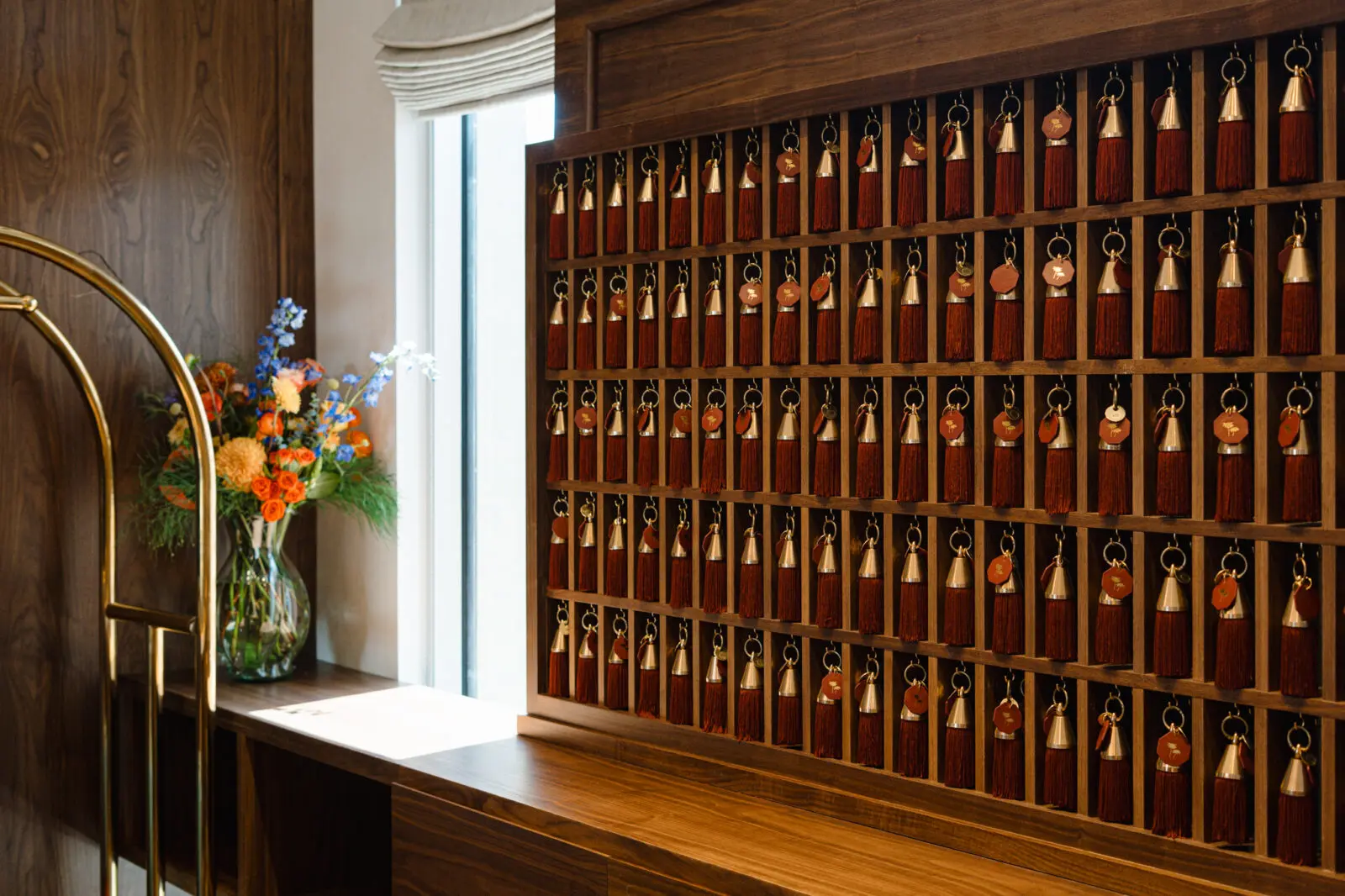 Oversized tassel room keys and warm walnut finishes set the tone at Caravan Court Hotel's reception desk. (Courtesy)