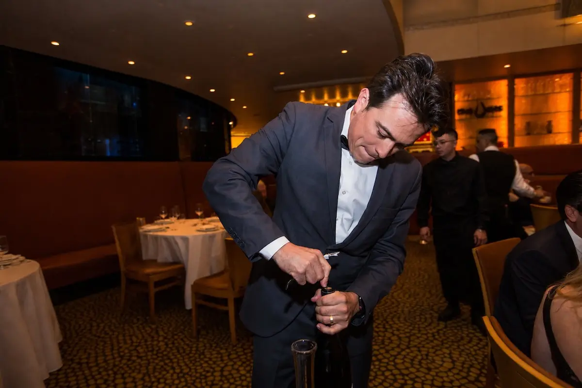 Carlos Luján uncorks a bottle at Tony's. (Andrew Hemingway)