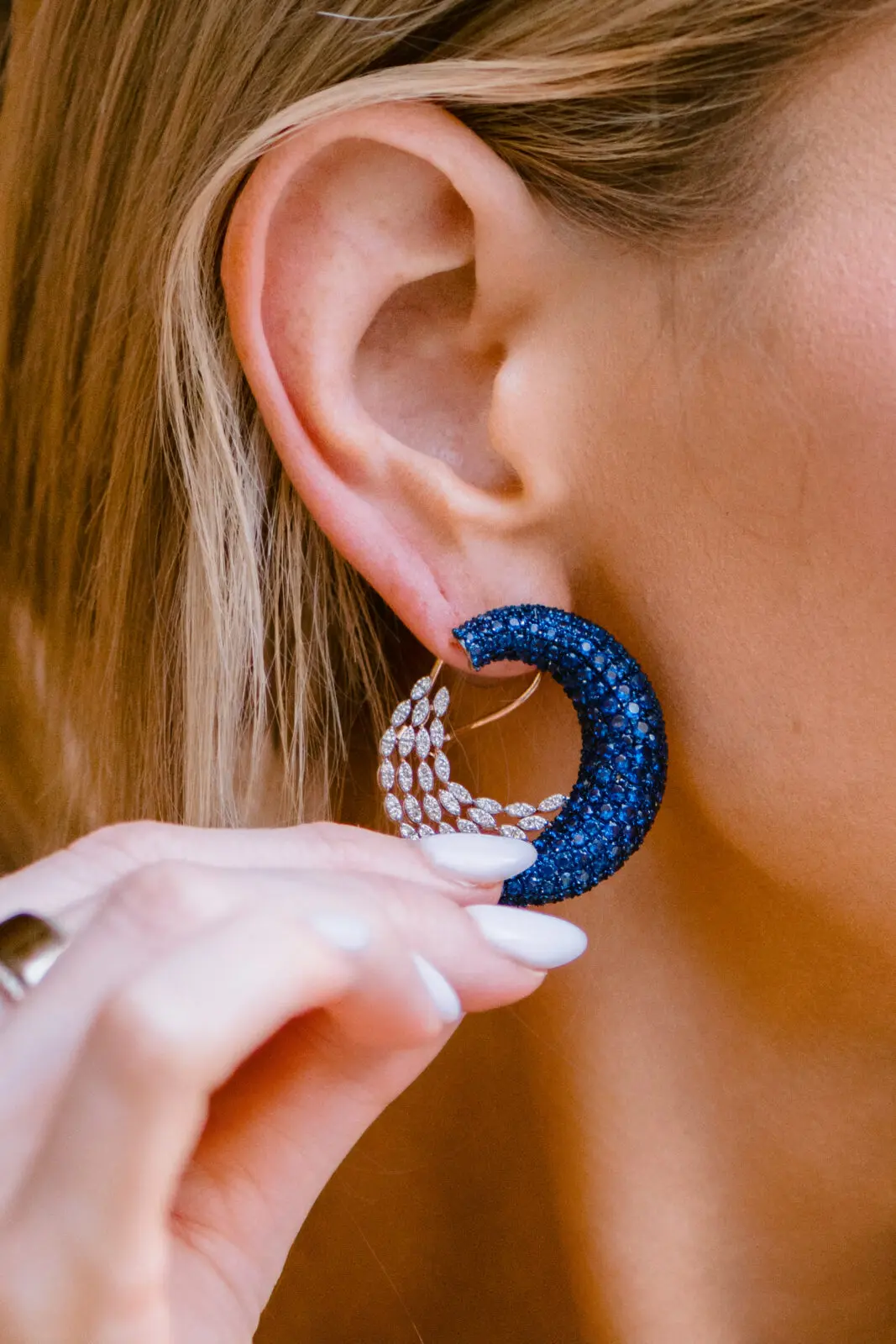 Fourteen karat rose gold peacock-inspired studs from SĀMAÁ Diamonds worn by Danielle Dubois (Photo by Si Vo Photography)