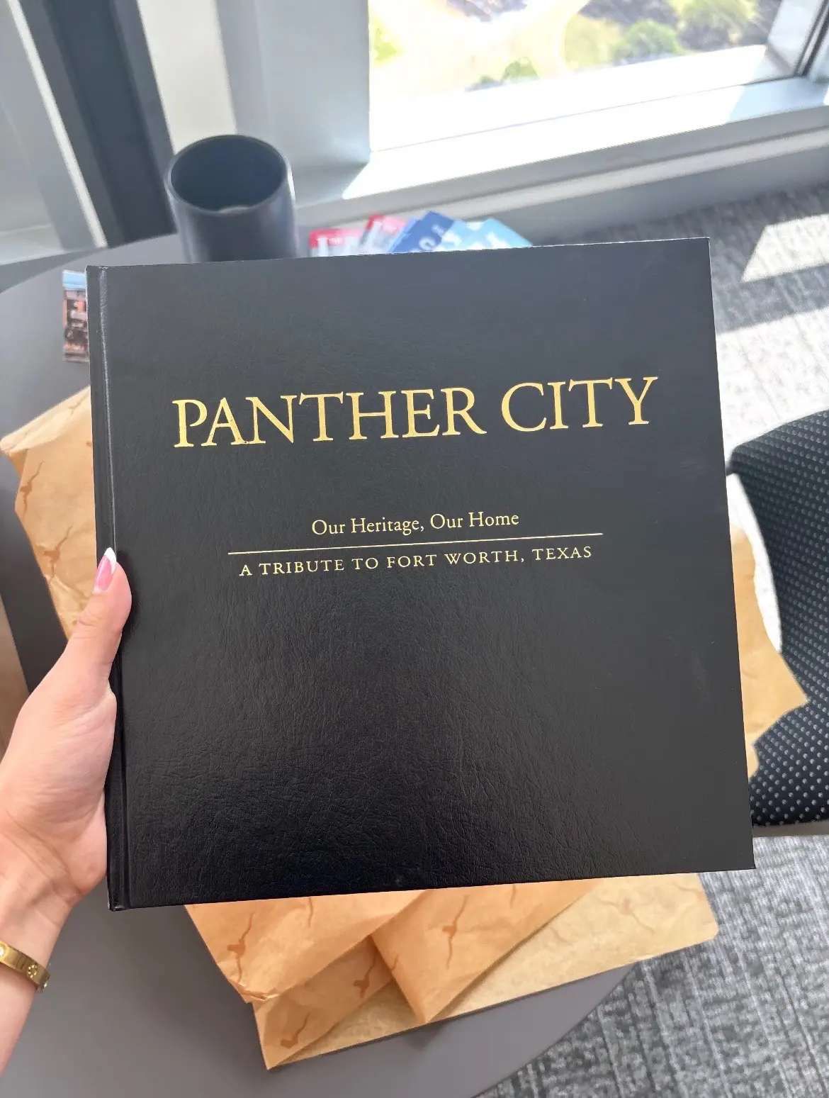 A copy of Panther City: Our Heritage, Our Home was presented to Princess Takamado by the City of Fort Worth. (Photograph by Brooks Burris for Visit Fort Worth)
