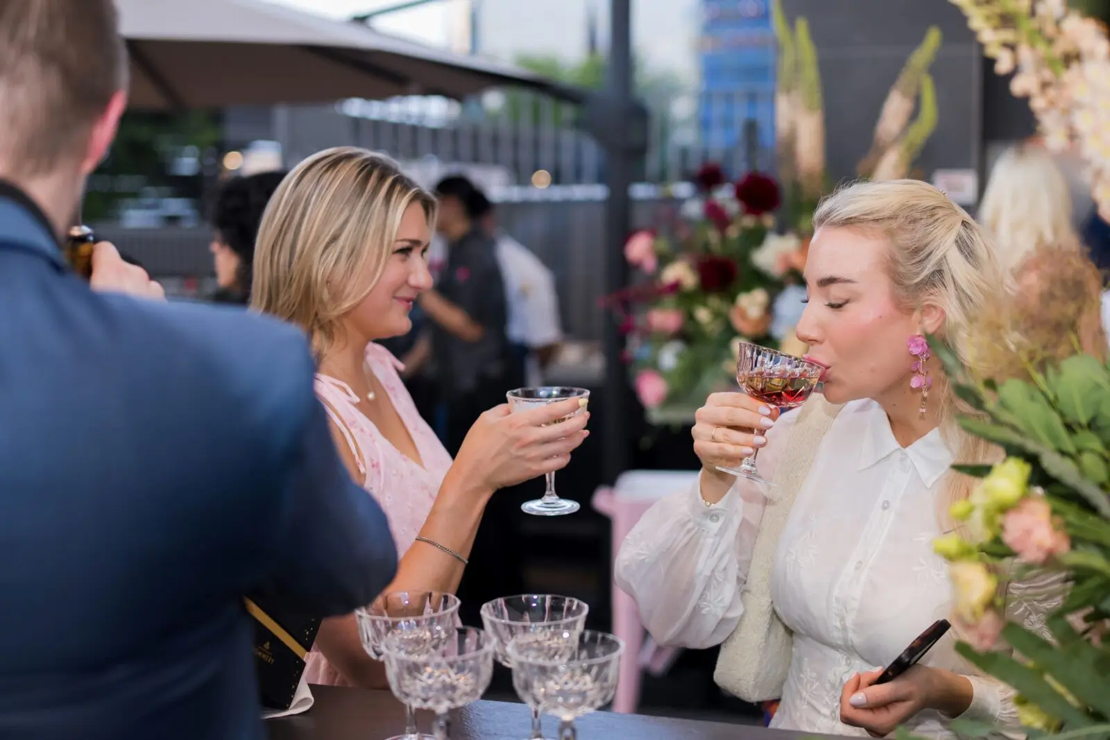 Invited guests gathered among lush botanicals and sweeping skyline views.