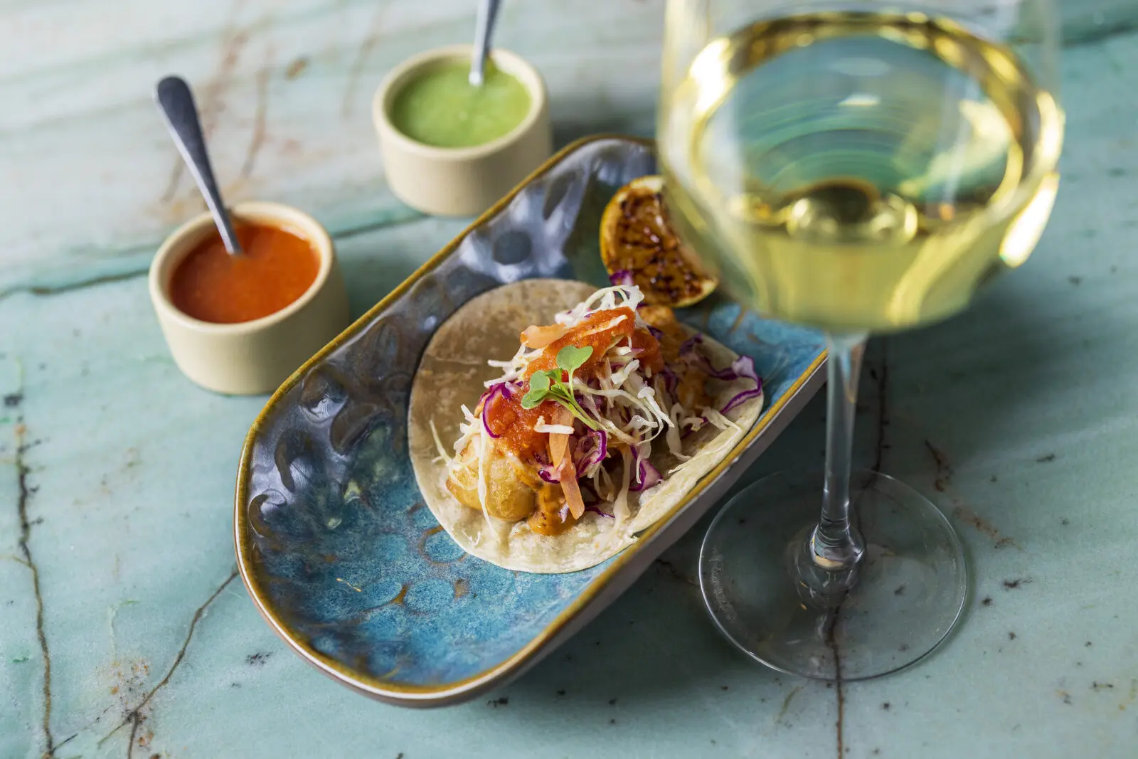 Part of Dos Mares' new happy hour menu, the Tacos Estilo Baja are available for $6 and feature shrimp tempura topped with garlic aioli and cabbage salad. (Courtesy)
