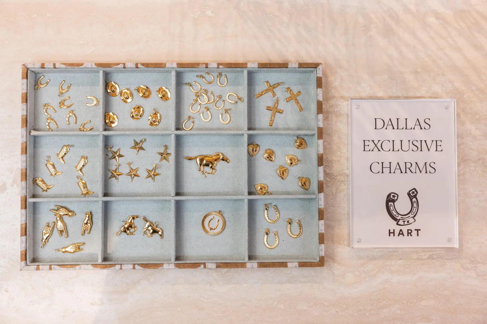 Customers can design their own custom charm necklace to reflect their story. (Photo by Kathy Tran)