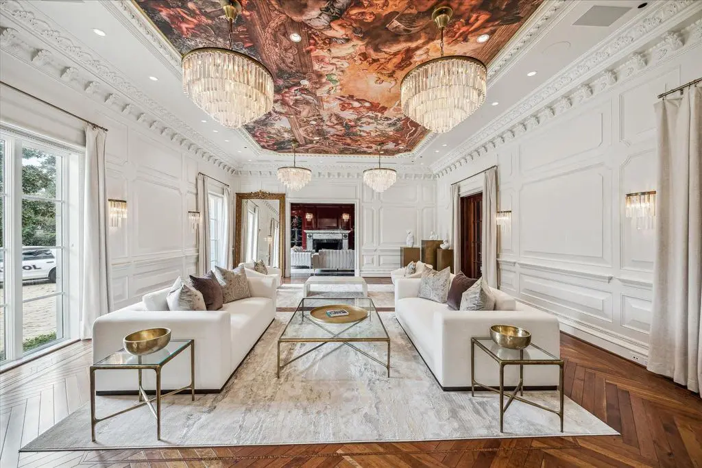 The elaborately painted ceiling adds drama to the living room at 1708 River Oaks Bou0levard