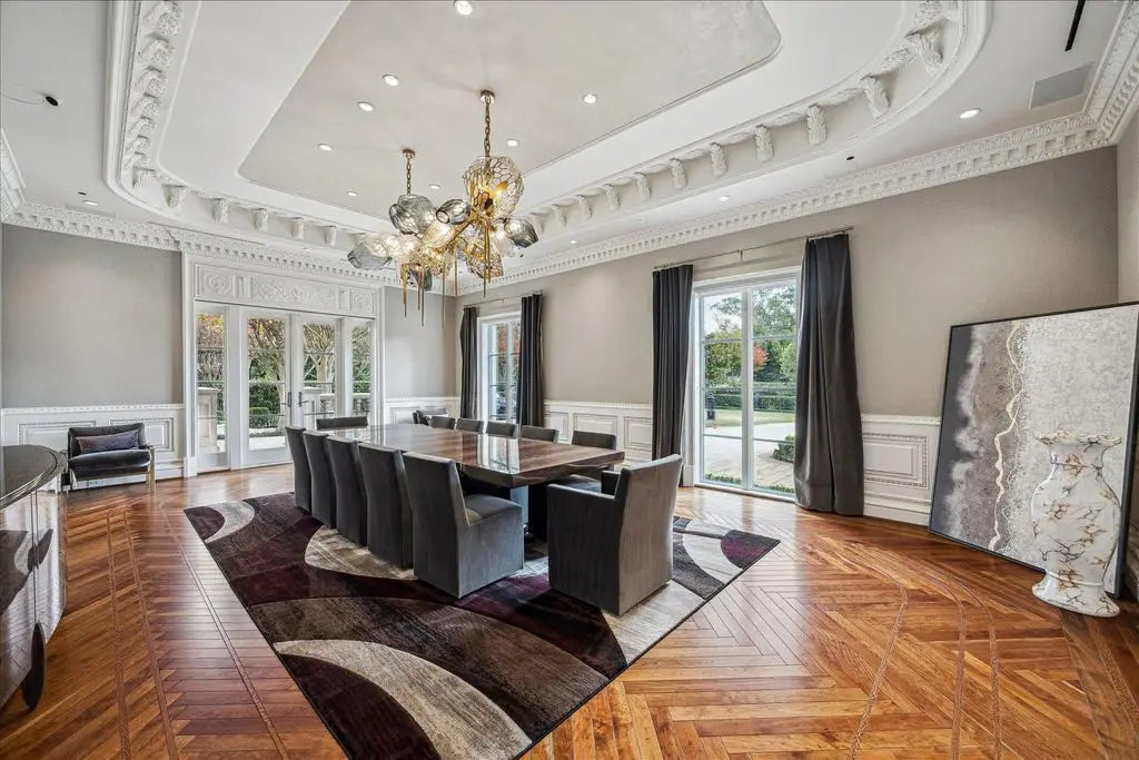 Dramatic hardwood flooring and the cove ceiling create dramatic tableau in the formal dining room,