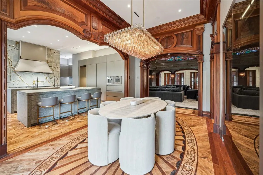 Elaborate millwork, flooring and marble accent the chef's kitchen and breakfast area.