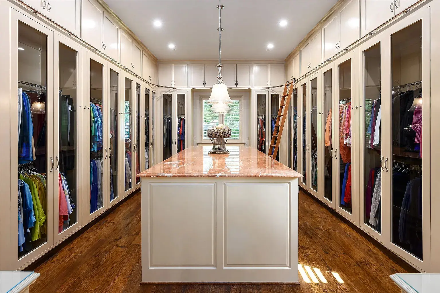 The primary suite features expansive his and hers closets with enclosed storage. (Photo by Dave Perry Miller Real Estate)