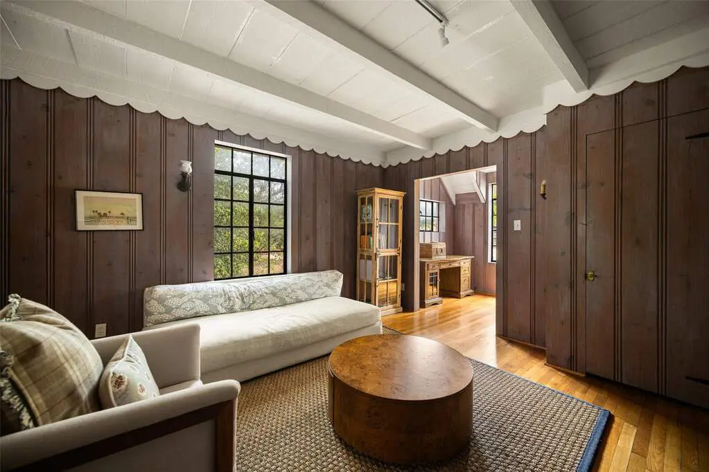 The home features preserved original details, millwork, Charles Dilbeck-inspired design elements, original steel casement windows, exposed beams, and European influence.