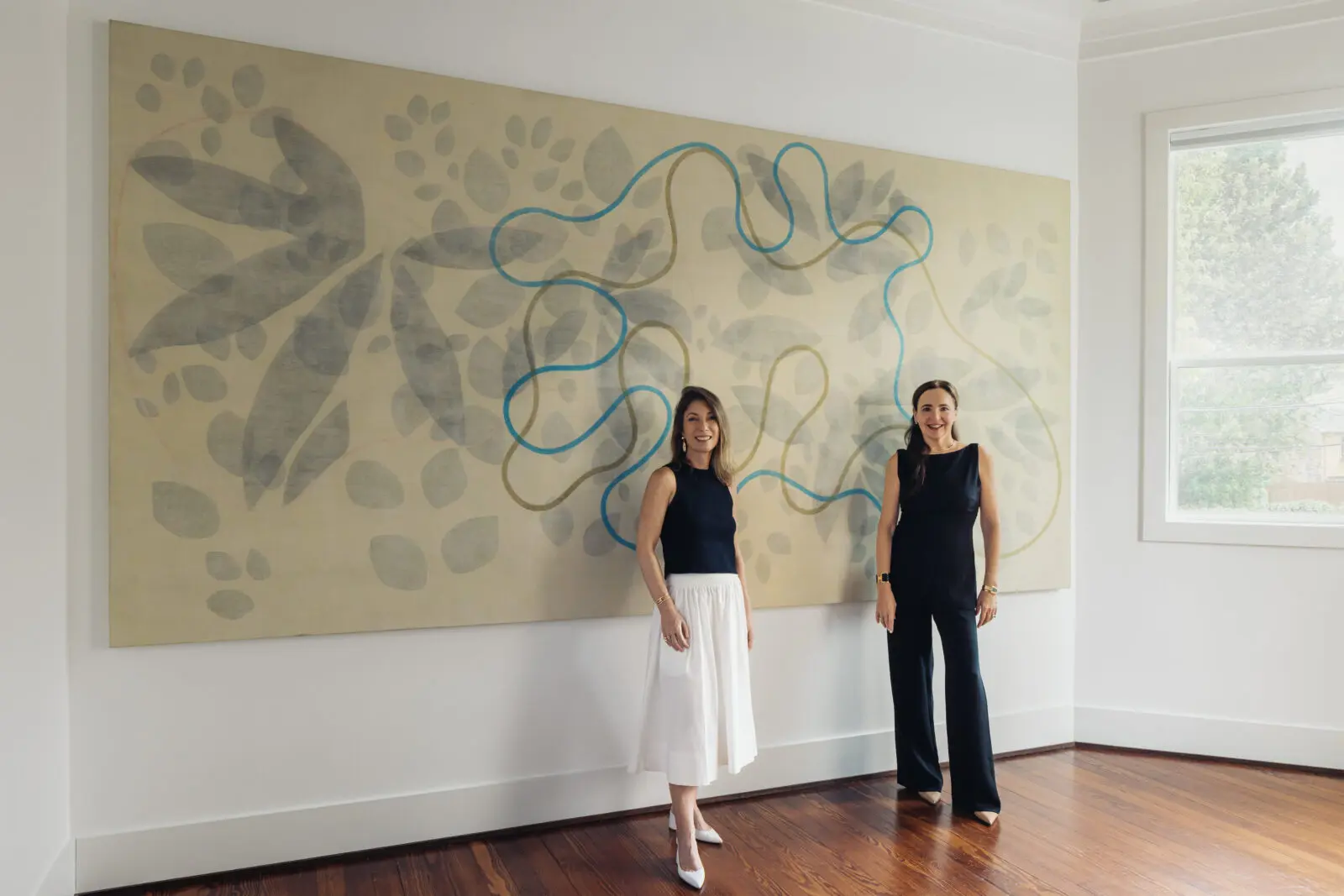 PAC Art founder Paola Creixell (right) with curator Simone Coscarell, founder Plural Arte y Cultura. Artwork Alejandro Corjueria. The pair are shown in PAC Art House's "Poetics of Matter," public opening Saturday, October 3, 11 am. (Photo Francisco Ramos)